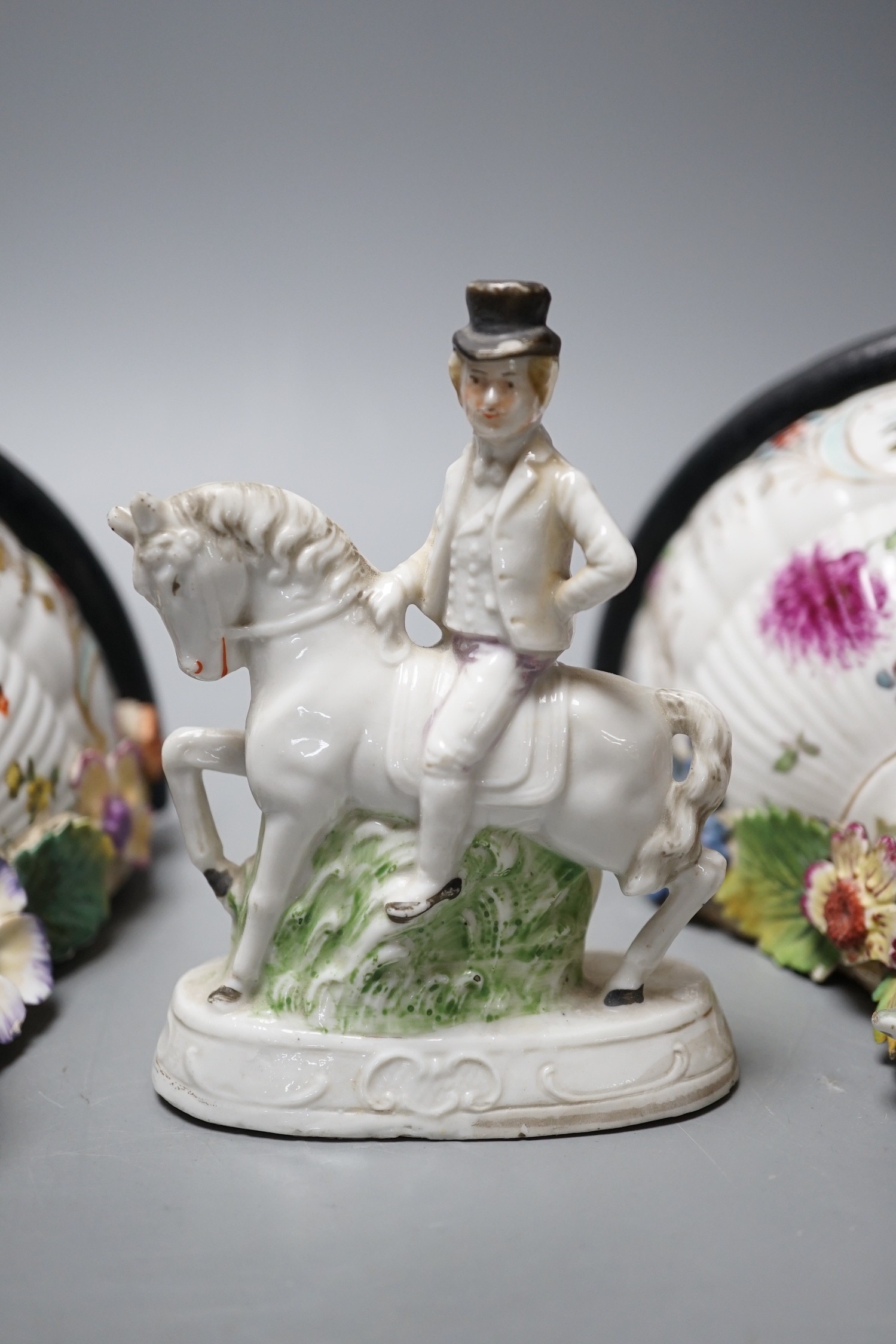 A pair of Dresden porcelain wall brackets and a pair of porcelain horses and riders, 12cm tall